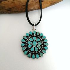 This stunning Squash Blossom pendant was handcrafted in Mexico.Each teardrop bezel is inlaid with turquoise coloured enamel enhanced with tiny brown flecks.Surrounding the centre blossom is a woven wire accent.Complete with an 18" inch black cord ready to wear! The pendant is approximately 2" inches long. This piece is silver plated.The pattern of the enamel may vary very slightly, they are all individually hand crafted.If you've got any questions don't hesitate to ask me.This pendant comes gift Turquoise Concho Bohemian Necklace, Bohemian Blue Turquoise Necklace With Concho, Southwestern Teardrop Jewelry For Festivals, Turquoise Bohemian Concho Necklace, Bohemian Blue Turquoise Concho Necklace, Southwestern Style Adjustable Teardrop Necklace, Blue Bohemian Concho Necklace, Bohemian Blue Concho Necklace, Turquoise Teardrop Necklace In Southwestern Style