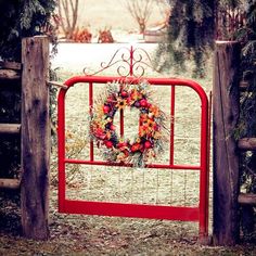 a red gate with a wreath on it