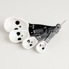 four black and white spoons with faces on them