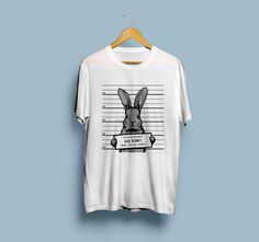 Bad Bunny Unisex T-Shirt, Funny Rabbit Art Shirt, Cute Easter Men Tshirt, Trendy Police Women Tee, Adorable Criminal Animal Print Tee Gift ❗ NEED ANOTHER T-SHIRT SIZE? Or maybe you prefer another color you haven't find in our chart? Just drop us a message and we'll see what can be done. You're always welcome! 👕 About the t-shirt: ▫ Classic unisex style (men/women) ▫ Short sleeve ▫ Soft cotton ▫ Light fabric (4.2 oz/yd² (142 g/m ▫ Fiber composition - 100% airlume combed and ringspun cotton (heat Novelty White Crew Neck Top, White Novelty Crew Neck Top, White Band Merch T-shirt With Funny Print, White Novelty Crew Neck T-shirt, White Novelty Shirt With Funny Print, Novelty White T-shirt For Streetwear, White Novelty T-shirt For Streetwear, Novelty White Pre-shrunk Shirt, White Novelty Shirt Pre-shrunk