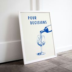 a white framed poster with blue ink pouring into a wine glass and the words pour decisions written on it