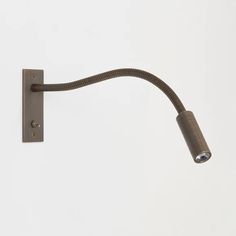 a wall mounted light with a cord attached to the back of it's arm