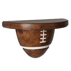 a wooden bowl with a football painted on the side and white stripes around the rim