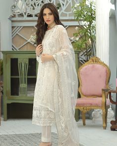 Pakistani Salwar Kameez Heavily Embellished Ivory Salwar Suit Dupatta comes with detailed florals bloom in moonlit tendrils on the dreamy ivory organza canvas. luxuriously laden with iridescent sequin, sparkling crystal Color thread creating an ethereal impact. Paired with a diaphanous net dupatta emblazoned with filigreed bootis, elaborately detailed borders and dramatically accented pants. Ivory Kameez: The kameez is emblazoned with lavish designs, embroidery, and floral designs. The fabric of Salwar Kamiz, Pakistani Salwar Kameez, Net Dupatta, Georgette Fabric, Salwar Suit, Fabric Stores Online, Embellished Dress, Designer Suits, Pakistani Fashion