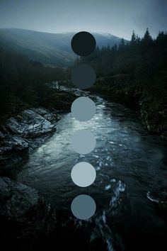 some circles floating in the air over a river