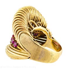 This stunning Mid-Century ring, crafted around 1945, showcases a beautiful arrangement of rubies and diamonds meticulously set in lustrous 14-karat yellow gold. The ring is adorned with a total of nine (9) round mixed-cut rubies, each measuring approximately 2.13-2.30 mm in diameter, and six (6) brilliant single-cut diamonds. It is also worth noting that the ring carries a partially obscured stamp, adding a sense of mystery and intrigue to its history. Additionally, the impressive ring has a substantial weight of 10.40 pennyweights, adding to its allure and presence.  Ring Size: 5.0 (approximate)  Dimensions: Width: 0.63" (from shoulder to shoulder) Length: 0.75  Style: Retro/Cocktail Condition: Very Good (for age/use of ring) Period: Circa 1945