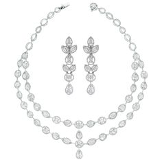 The Tara Necklace & Earrings Suite features a elegant timeless design that highlights each diamond and impresses with its simple yet stated style. Its bold earrings bring attention Diamonds Shapes: Pear Shape, Oval, Marquise & Round Total Diamonds Weight: 24.74 ct (Necklace) & 6.59 ct (Earrings) Diamonds Color: F - H Diamonds Clarity: SI (Slightly Included) Metal: 18K White Gold Metal Wt: 53 gms (Necklace) & 20.55 gms (Earrings) Setting: Prong Set Length: 15.5 Inches & 2.6 Inches Price Quoted ma Diamonds Shapes, Dna Earrings, Pearl Chandelier Earrings, Diamond Chandelier Earrings, Noble Lady, Stones Necklace, Earrings Chandelier, Aesthetic Edits, Tech Pack