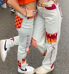 100% Customizable Gameday Jeans!! (Or for any special occasion) I would ask that you send me the pair of jeans you would want to be painted. Painted with acrylic and fabric paint. Will be shipped within 1-2 weeks. Football Game Jeans, Graphic Print White Bottoms For Fall, White Graphic Print Bottoms For Fall, Fall White Bottoms With Graphic Print, Casual Hand Painted Cotton Bottoms, Trendy Hand Painted Cotton Jeans, Senoir Jeans, Painted Overalls School Spirit, Senior Jeans Painted 2025