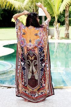 Want to shop for a dress that is comfortable, classy and elegant at the same time? Then this alluring Silk Kaftan dress with glittering crystal work is the best choice for you. The minimal V neckline sets a perfect combination with sassy sidelines of the silk Kaftan dress. The beauty of brown shade is more evident with tinge of orange, maroon, black and white. Swim wear kaftan Style it with white earrings and white heels for a relaxing day at beach. ONE SIZE FIT ALL KAFTAN ( Small to 8XL) Materi Bohemian Maxi Dress With Dabka, Bohemian Tunic Dress With Dabka Detailing, Long Kimono For Beach Eid Festival, Bollywood Style Tunic Dress For Festival, Bohemian Summer Kaftan With Dabka Detailing, Bohemian Dabka Maxi Kaftan, Bohemian Dresses With Kimono Sleeves For Eid, Long Bohemian Kaftan With Dabka, Bohemian Dabka Kaftan For Summer