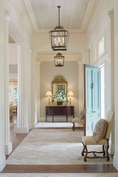 an elegant hallway with white walls and columns