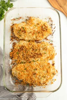 chicken parmesan casserole in a glass baking dish on a white table