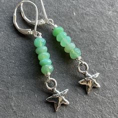 Bright beautiful faceted chrysoprase wired in sterling silver show off a sweet solid sterling silver artisan star. The approximate length is 1 7/8". The leverbacks shown are an upgrade. Please choose your earwire preference. Your jewelry will arrive beautifully giftboxed. Nickel-free Silver Chrysoprase Jewelry, Nickel-free Chrysoprase Jewelry Gift, Handmade Green Star-shaped Jewelry, Green Star-shaped Handmade Jewelry, Adjustable Silver Jewelry With Chrysoprase, Adjustable Silver Chrysoprase Jewelry, Pebble Jewelry, Hardware Jewelry, Silver Turquoise Earrings