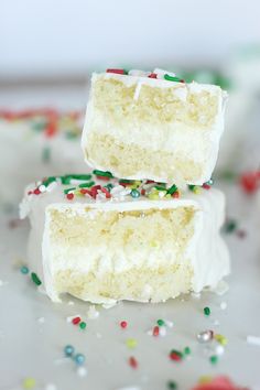 two pieces of cake with white frosting and sprinkles