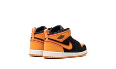 The Air Jordan 1 Mid TD "Vivid Orange" is the toddler sizing of the colorway of the casual shoe with orange accents.  The head-turning “Vivid Orange” Jordan 1 Mid features a black synthetic nubuck base with tonal overlays on the toe, forefoot, and eyelets.  Vivid Orange accenting is seen on the perforated leather toe, collar, heel, and Swoosh.  The blazing shade of orange can also be found on the Jumpman logo on the tongue.  A white rubber midsole and orange outsole complete the look.  Release d Air Jordan 1 Mid Orange, Metallic Orange Jordan 1, Mid-top Leather Jordan Shoes With Contrast Sole, Orange Jordan, Air Jordan 1 Mid Orange Black, Jordan 1 Mid Black/fire Red/white, Jumpman Logo, Orange Shoes, Casual Shoe