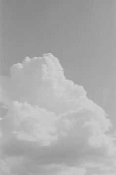 an airplane is flying in the sky with clouds