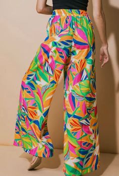 •Tropical Patterned Flowy Pants •Bright bold colors •Elastic waist •Wide leg •100% polyester •Hand wash cold •Tumble dry low •Matching top sold separately Casual Colorful Wide Leg Bottoms, Trendy Colorful Bottoms For Spring, Trendy Colorful Pants For Spring, Trendy Colorful Spring Pants, Trendy Colorful Spring Bottoms, Multicolor Beach Pants For Spring, Multicolor Beach Pants For Beach Season, Colorful Wide Leg Bottoms For Spring, Multicolor Pants For Beach And Spring Season