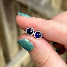 Simply Bold introduces to you one of a kind Sapphire post earrings featuring round, rose cut, blue Sapphire stones set in fine silver bezels. These stones are a gorgeous deep blue, and are rose cut making them sparkle off of the ear. They are also a great everyday post earring.  I used a 24 gauge sterling back plate and nice and sturdy long sterling posts for comfort in the ear. They also come with strong and secure backings to make sure an earring isn't lost. These earrings are small and dainty Blue Sapphire Earrings, Earrings Sapphire, Sapphire Stud Earrings, Sapphire Stones, Sapphire Earrings Studs, Sapphire Studs, Sapphire Earrings, Earrings Blue, Sapphire Stone