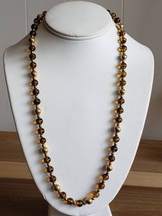 This is a vintage Napier, gold tone metal beads and glass beads necklace. There is a bit of the chain that doesn't have beads on it, as you can see in images. The beads can move on the necklace, slightly. This measures 25.25 inches across. Don't forget to stop in at my other Etsy shop... http://www.etsy.com/shop/xtdesigns. Follow me on Twitter at... MyYiayiaHadThat@MyYiayiaHadThat. If you have a wish list or are looking for something specific, please ask. I may have exactly what you are looking Gold Beaded Long Necklace For Parties, Gold Single Strand Beaded Necklace For Party, Vintage Polished Gold Beads, Vintage Gold Polished Beads, Costume Jewelry Necklaces With Round Beaded Chain, Gold Beaded Necklaces With Large Beads For Party, Gold Beads For Long Necklace Party, Gold Long Necklace With Round Beads For Gift, Vintage Gold Jewelry With Beaded Chain