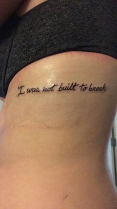 a woman with a tattoo on her stomach saying i was not built to banish