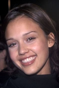 a close up of a person smiling at the camera