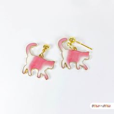 Add a touch of whimsy to your outfit with these adorable Pink Cat Enamel Earrings! Perfect for cat lovers and kawaii enthusiasts alike, these dainty accessories capture the essence of cute and quirky fashion.  🌸✨ Specification ✨🌸 * 18k Gold Plated Earrings * Enamel Charm Size is approx. 2.5 x 2.5 cm Handmade with love, each earring features an irresistibly charming pink cat that's sure to make a statement and bring joy wherever you go. Whether you're looking for a unique gift or a fun addition Novelty Pink Enamel Jewelry, Trendy Cat Ears Earrings For Gift, Trendy Cat Ears Earrings As Gift, Novelty White Cat Design Jewelry, Cute Cat Ears Earrings With Cat Print, Pink Cat Design Jewelry With Cat Ears, Cute Cat Design Adjustable Earrings, Adjustable Cute Cat Design Earrings, Kawaii White Drop Earrings