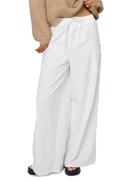 Cotton and linen add airy ease to slouchy wide-leg cargo pants topped with a comfortable elastic-drawstring waist. 70% cotton, 30% linen Machine wash, line dry Imported Spring Vacation Cargo Pants, Summer Wide Leg Cargo Pants For Loungewear, Wide Leg Summer Cargo Pants For Loungewear, Cotton Cargo Pants For Vacation, Casual Cotton Parachute Pants For Vacation, White Baggy Harem Pants For Vacation, Baggy White Harem Pants For Vacation, Chic Summer Cargo Pants For Loungewear, Spring Beach Parachute Pants With Pockets