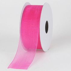 a roll of pink satin ribbon on a white background