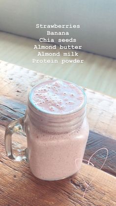 a mason jar filled with almond milk on top of a wooden table