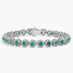 Get lost in the 360-degree sparkle of this 18k white gold bracelet designed with a string of round emeralds surrounded by delicate diamond halos that reflect a delightful display of color and light. Luxury Formal Bracelet With Halo Setting, Luxury Formal Bracelets With Halo Setting, Formal White Gold Diamond Bracelet With Emerald, White Gold Diamond Bracelet With Gemstone, Green Diamond Bracelets With Brilliant Cut, Green Diamond Bracelet With Brilliant Cut, Luxury Diamond Bracelets With Halo Setting, Emerald Diamond Bracelet In White Gold For Formal Events, Elegant White Gold Diamond Bracelet With Emerald