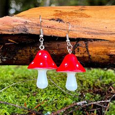 These little red mushroom dangle earrings celebrate the most iconic mushroom of all: amanita muscaria! These earrings have bright red mushroom caps with white spots and white stems. These earrings would be a perfect addition to Goblin Core or Cottage Core outfits, or a great gift to any nature loving friend or faerie.Each earring measures 1 1/4" long by 1" wide Mushroom Designs, Red And White Mushroom, Amanita Mushroom, Mushroom Caps, Core Outfits, Cottage Core Style, Amanita Muscaria, Mushroom Earrings, Red Mushroom