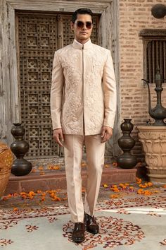 Peach bandhgala with geometric stitch line work on base, 3D tonal floral garden needle and French knots anchor threads embroidery. Comes with coordinated colored pant. - Aza Fashions Fitted Kurta With Chikankari Embroidery For Ceremony, Bandhgala With Resham Embroidery For Eid Ceremony, Ceremonial Bandhgala With Resham Embroidery For Eid, Eid Ceremony Bandhgala With Resham Embroidery, Anchor Threads, Stitch Lines, Katan Silk, French Knots, Colored Pants