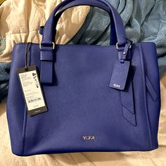 This Gorgeous Tumi Varek Handbag In Royal Blue Is Brand New With Tags. It’s Classy, Eye Catching, And Boasts Of That Durable, High Quality Craftsmanship We’ve Come To Love From Tumi. Blue Shopping Bag With Top Carry Handle, Blue Shopping Bag With Detachable Handle, Blue Top Handle Bag For Office, Modern Blue Top Handle Bag, Blue Tote Bag For Office, Blue Top Handle Satchel For Evening, Blue Tote Office Bags, Chic Blue Bags For Shopping, Evening Blue Top Handle Satchel