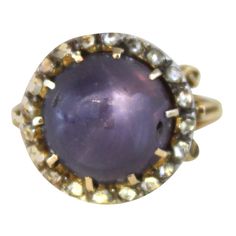 The centre stone of this lovely Victorian ring is a purple star sapphire. The sapphire is natural and a transparent stone with a beautiful star that is well centered and shows a distinct and crisp 6 ray star. The weight of the sapphire is ca. 7 carats and it is surrounded by old rose-cut diamonds. Ring size 6.5, can be resized. Victorian Purple, Dome Rings, Star Sapphire Ring, Purple Star, Victorian Ring, Purple Rings, Victorian Rings, Star Sapphire, Diamond Star