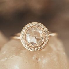 a diamond ring sitting on top of a rock