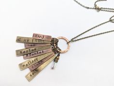 Please read: Personalized FAMILY NECKLACE- Hand pounded on an old-fashioned anvil one letter at a time. The letters will no doubt be uneven and rustic with a variance in depth and spacing. Tags alternate between antique brass/copper. Family necklaces make a wonderful keepsake. Whether for yourself or as a gift, add your children, Bible verses as you wish. Charms CAN be added as families grow. Mom/dads initials w/heart between or a wedding date also works well on one charm. - - - - - - - - - - - Children Bible Verses, Children Bible, Mother Necklace Personalized, Aqua Stone, Family Necklace, Kids Names, Blue Sodalite, Mothers Necklace, Garnet Stone