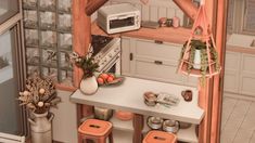 a small kitchen with an oven, table and stools