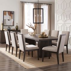 a dining room table and chairs with beige upholstered chairs in front of a window