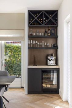 a dining room table with chairs and a wine rack