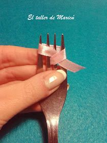 a person holding a fork with a bow on it