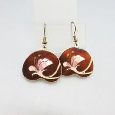 These fun Cloisonne' Enamel Earrings are done in goldtone metal with a white and pink flower against a rich brown background. The earrings are French hook style and are in near mint condition.  They are not marked. They measure 1 5/8ths inches tall and 1 1/8ths inches wide.  We will send these to you in a lovely gift box for easy gift giving If you like vintage accessories, vintage costume jewelry, old bolo ties and silver jewelry,  please see my Etsy store for more selections, www.etsy.com/shop Brown Flower Drop Earrings, Retro Flower-shaped Earrings For Gift, Retro Flower Earrings For Gift, Retro Flower Shaped Earrings For Gift, Retro Flower Shape Earrings For Gift, Retro Flower Shaped Earrings As Gift, Vintage Pink Flower-shaped Earrings, Vintage Enamel Flower Earrings, Vintage Brown Drop Earrings