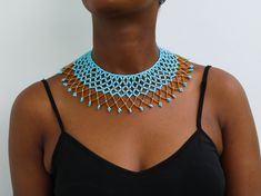 African beaded shawl necklaces, Beaded cape necklaces, Beaded wedding necklace, Statement necklace, Christmas gift for her, Tribal necklace A 100% handmade in Kenya necklace. Can fit any body type as it layers well with the body *Color: light blue and gold *Necklace height:  3 inch/7 cm *Neck size length : 13.5 inch / 34 cm (Adjustable and extends up to 16 inch/ 41cm * Available in different colors. Please select your color (Gold color remains constant) * 3-5 days delivery via shipping via DHL E Wedding Beaded Necklaces With Tiny Beads, Wedding Tiny Beads Necklace, Adjustable Beaded Necklaces For Celebration, Celebration Beads With Large Beads, Gold Beads Bib Necklace Gift, Beaded Bridal Necklace Gift, Gift Bib Necklace With Large Beads, Blue And Gold Necklace, African Beaded Necklace