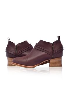 Slip into comfortable Western-inspired handmade Dasha booties that are ideal for all-day walking. Featuring wild-west strap detailing these leather boots are designed with a heel height that is just enough to make you feel stylish and comfortable when strolling through the city. The low-cut silhouette pairs perfectly with everything from cropped denim to midi skirts and offers a stylish look. 100% genuine leather Smooth leather lining and insole with embossed logo Lightly padded footbed Leather Leather Lined Ankle Moto Boots For Fall, Fall Wedge Ankle Boots With Leather Sole, Fall Moto Boots With Leather Sole And Low Heel, Fall Leather Sole Ankle Booties, Fall Ankle Booties With Leather Sole, Fall Ankle Wedge Boots With Stacked Heel, Fall Ankle Booties With Leather Lining, Leather High Ankle Booties With Stacked Heel, Moto Ankle Boots With Stacked Heel For Work