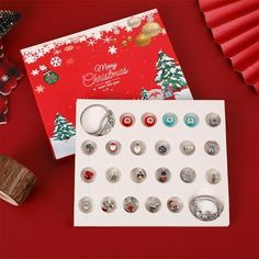 a christmas card with lots of buttons and magnets on it next to a bunch of other items