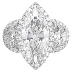 an oval cut diamond ring with three pear shaped diamonds