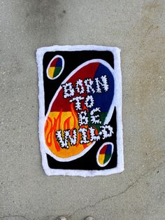 a patch with the words born to be wild written on it and a pair of shoes next to it