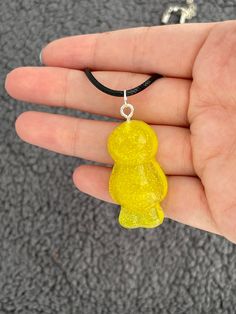 This adorable necklace will help you stand out anywhere you go with its vibrant colour and super sparkly finish.  This adorable jelly baby is made from epoxy resin filled with yellow mica powder and yellow glitter.  Measures approx. 2cm x 3.5cm x 1cm Yellow Resin Jewelry For Party, Yellow Resin Jewelry For Gifts, Cute Yellow Resin Jewelry, Yellow Resin Jewelry As Gift, Yellow Resin Jewelry Gift, Yellow Resin Jewelry As A Gift, Cute Yellow Necklace For Gifts, Cute Yellow Necklace For Gift, Epoxy Resin Necklace