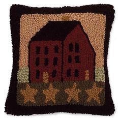 a decorative pillow with a red barn on it