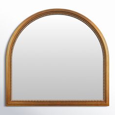 an arched mirror hanging on the wall