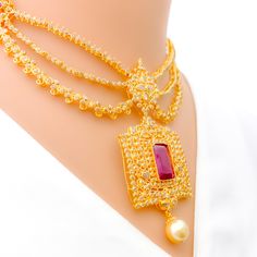 Crafted with exquisite attention to detail, this 22k yellow gold set weighs 54.8 grams and features a royal vintage design. It is adorned with uncut diamonds (Polki), totaling 11.18 carats, and further embellished with rubies and pearls, collectively weighing 34.2 carats. The set has a length of 16 inches, with an impressive drop length of 2.2 inches, and is secured with a hook lock and adjustable links for tailored comfort. The matching earrings, at a length of 2.1 inches, complete the set, eac Traditional Gold Pearl Necklace For Formal Occasions, Gold 22k Pearl Necklace For Wedding, Festive Gold Bridal Necklace With Pearl Pendant, Formal Festive Yellow Gold Pearl Necklace, Formal Gold Kundan Pearl Necklace, Ceremonial Gold Pearl Necklace In Temple Jewelry Style, Gold Pearl Necklace For Formal Festive Occasions, Ceremonial Gold Temple Jewelry Pearl Necklace, Festive 22k Gold Pearl Necklace