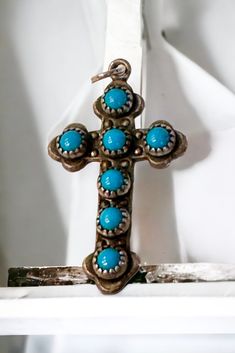 Excellent vintage condition.  No scratches or wear marks.  No chain.   Cross is 1". I am told the symbol is Bell Trading Company.  All of my jewelry is wiped down with alcohol to ensure cleanliness. Vintage Turquoise Necklace With Oxidized Finish As Gift, Vintage Turquoise Pendant Necklace With Patina, Vintage Blue Turquoise Necklace With Concho, Vintage Handmade Cross Jewelry, Handmade Vintage Cross Jewelry, Vintage Turquoise Concho Necklace, Vintage Sterling Silver Concho Turquoise Necklace, Vintage Sterling Silver Turquoise Concho Necklace, Vintage Turquoise Concho Necklace In Sterling Silver